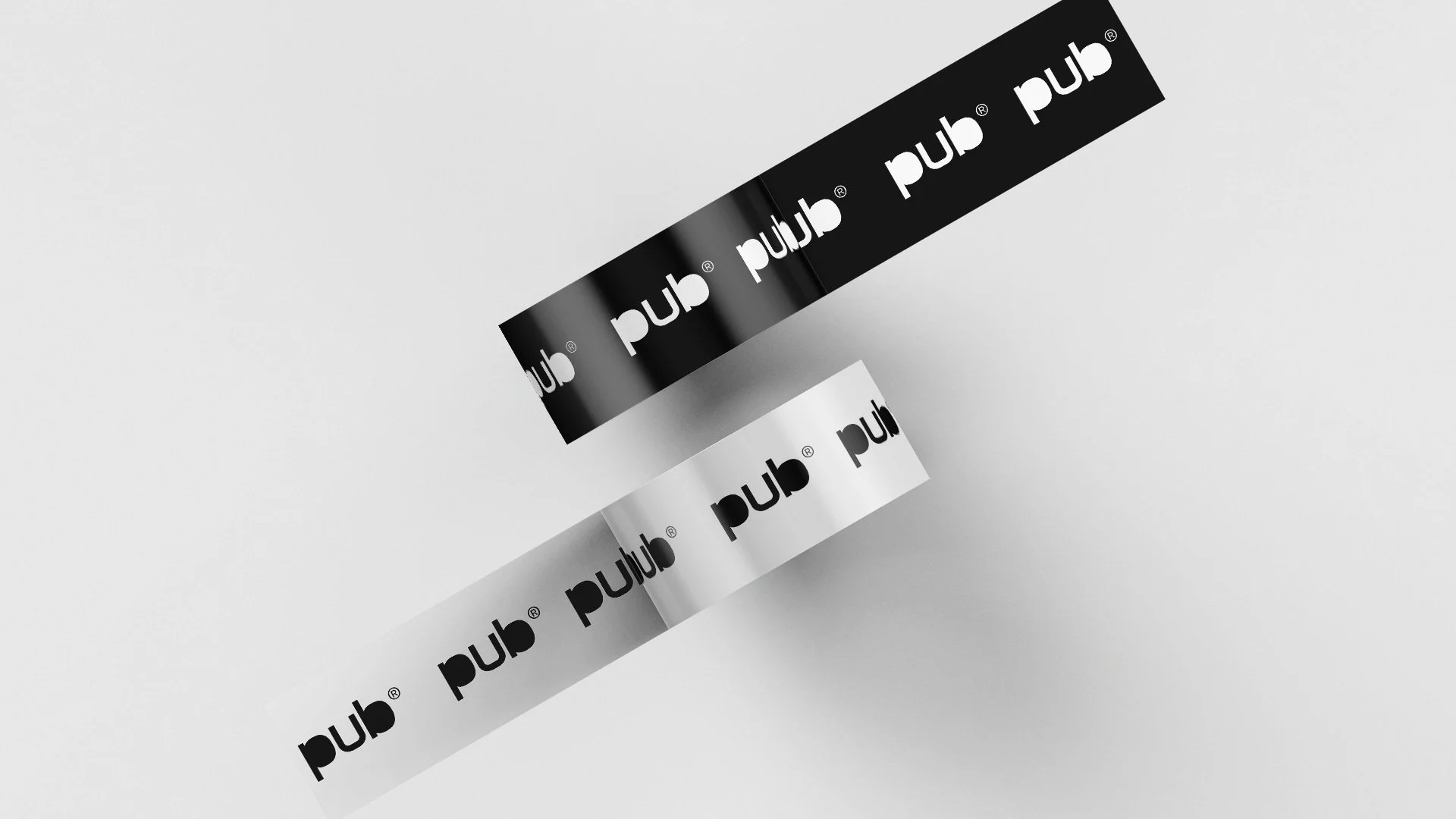 Black and white ribbons showing the PUB wordmark and symbol