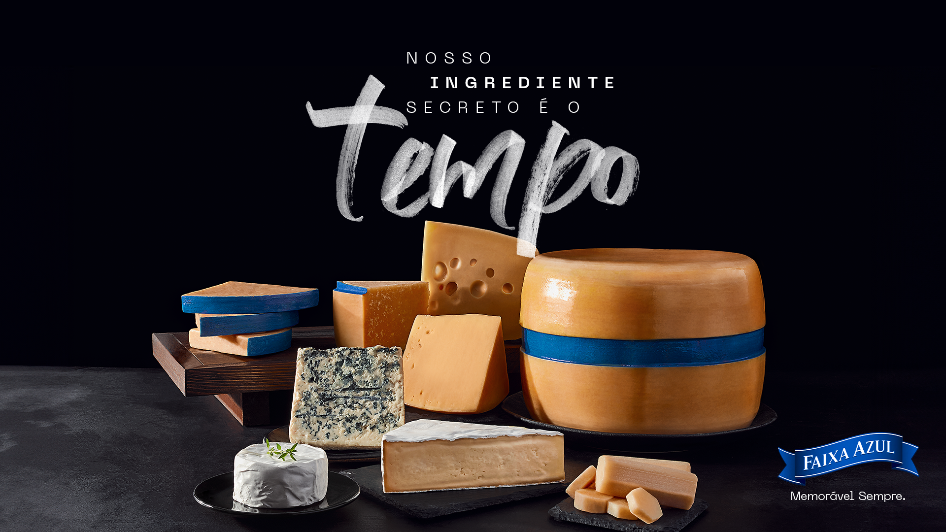 Faixa Azul range of aged cheeses arranged on a dark background beneath the campaign message “Nosso ingrediente secreto é o tempo.”