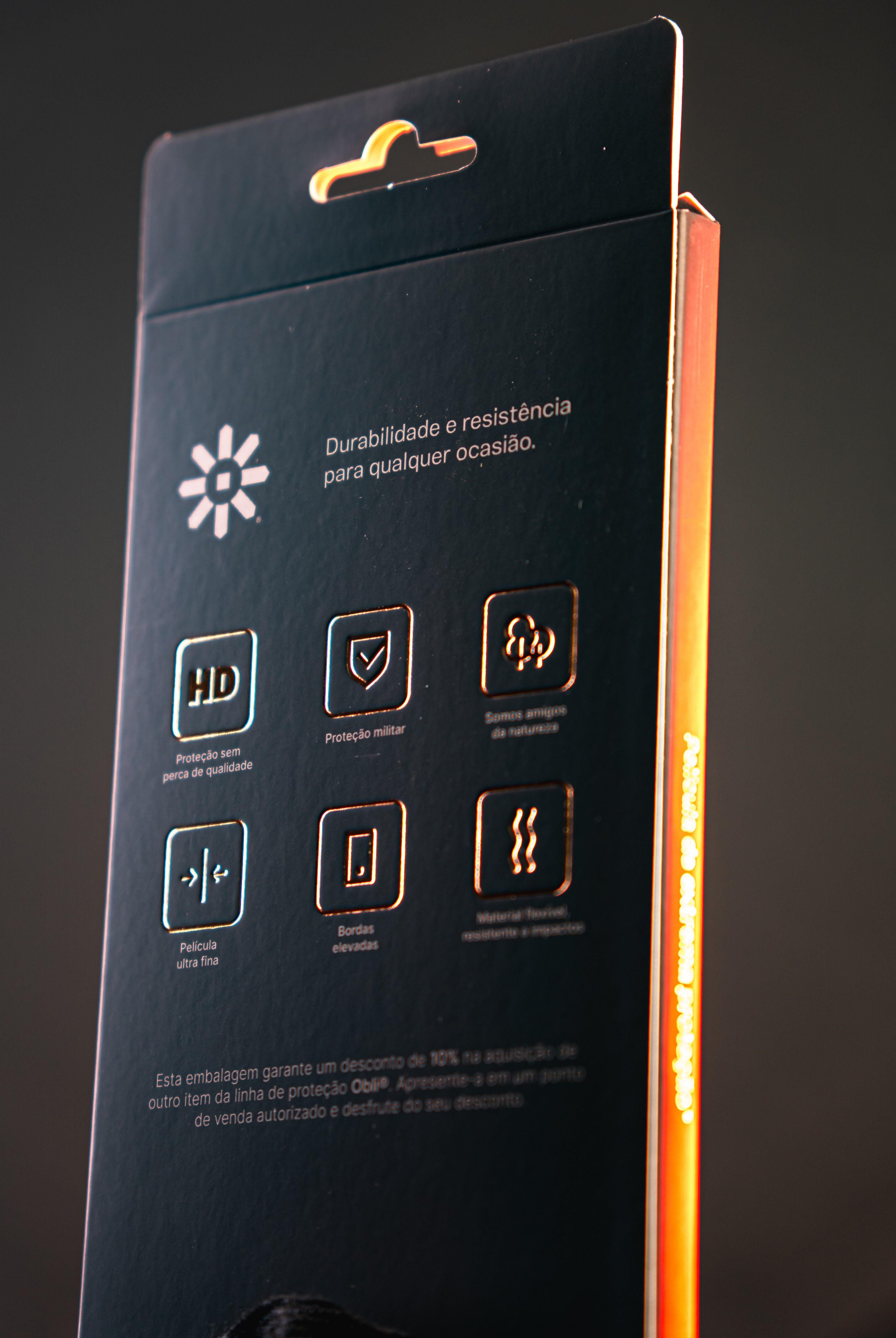 Obli smartphone accessory packaging reverse side, with product feature icons on black and an orange side panel.