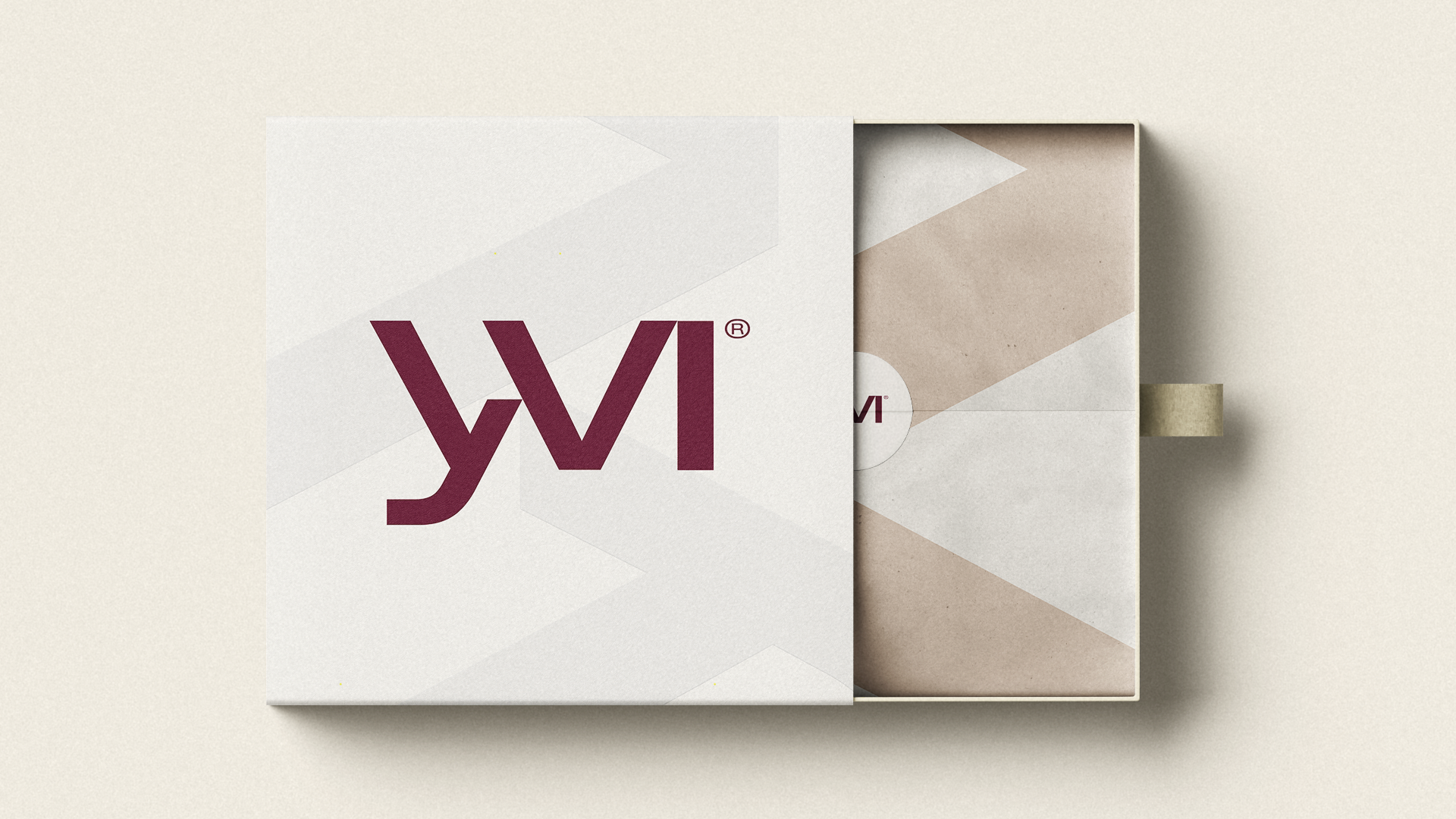 Yvi printed brand stationery in cream, with the burgundy logo and geometric folds.