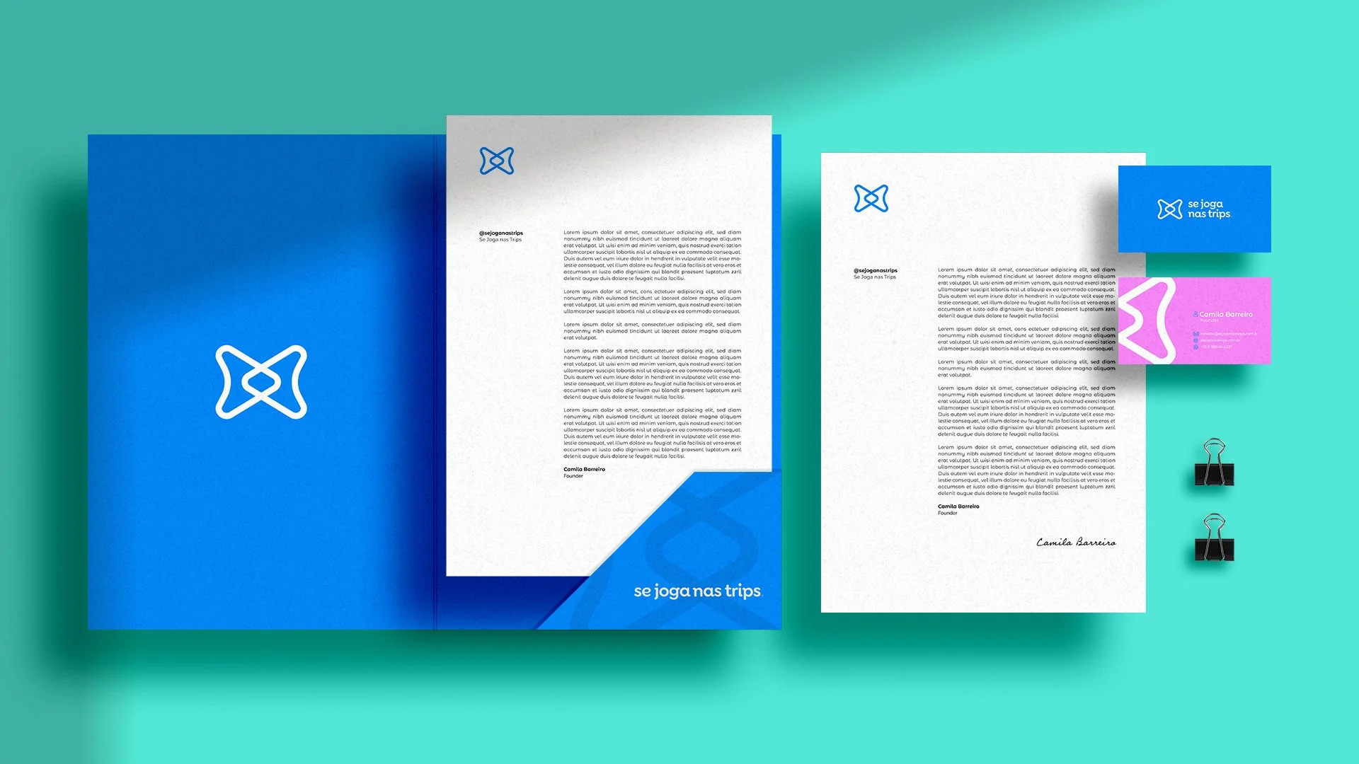 Se Joga Nas Trips stationery with blue folders, white letterheads and blue and pink business cards on a turquoise background.