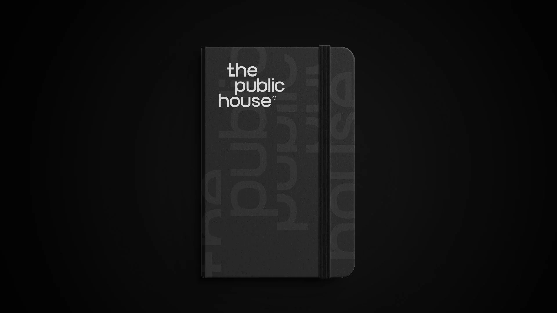 The Public House black notebook with a repeating wordmark pattern and a white logo on the cover.