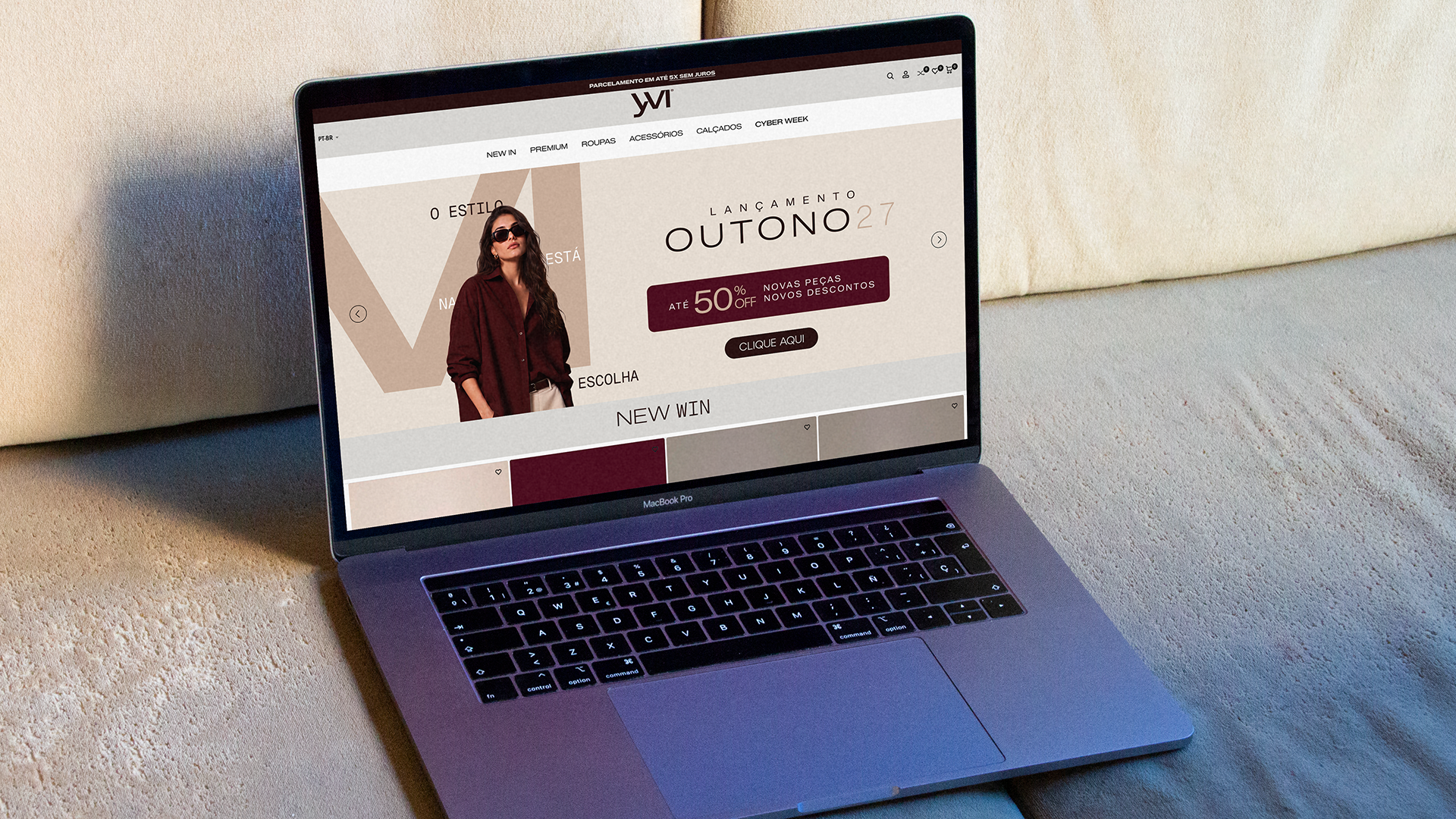 Yvi e-commerce website displayed on a laptop, with fashion photography and the autumn campaign in cream and burgundy.