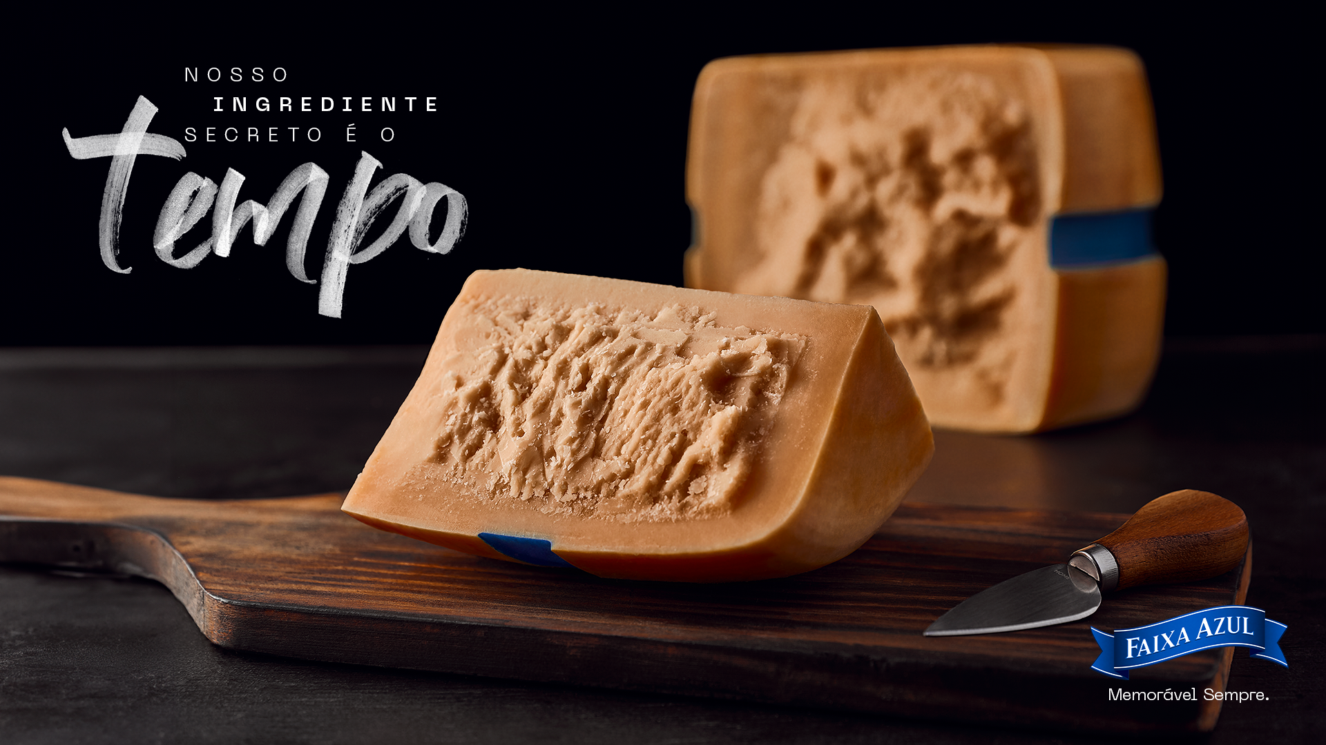 Faixa Azul aged cheese wheel and wedge on a wooden board, highlighting its texture beside the campaign message about time.